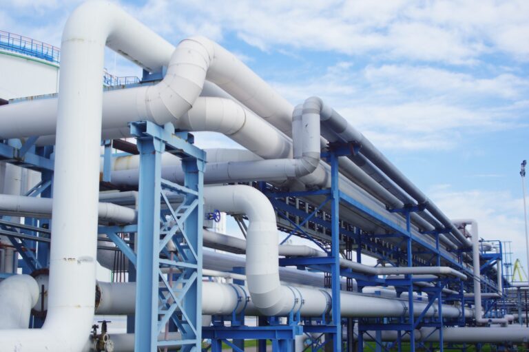 closeup-industrial-pipelines-around-factor-sunny-day-scaled-768×511